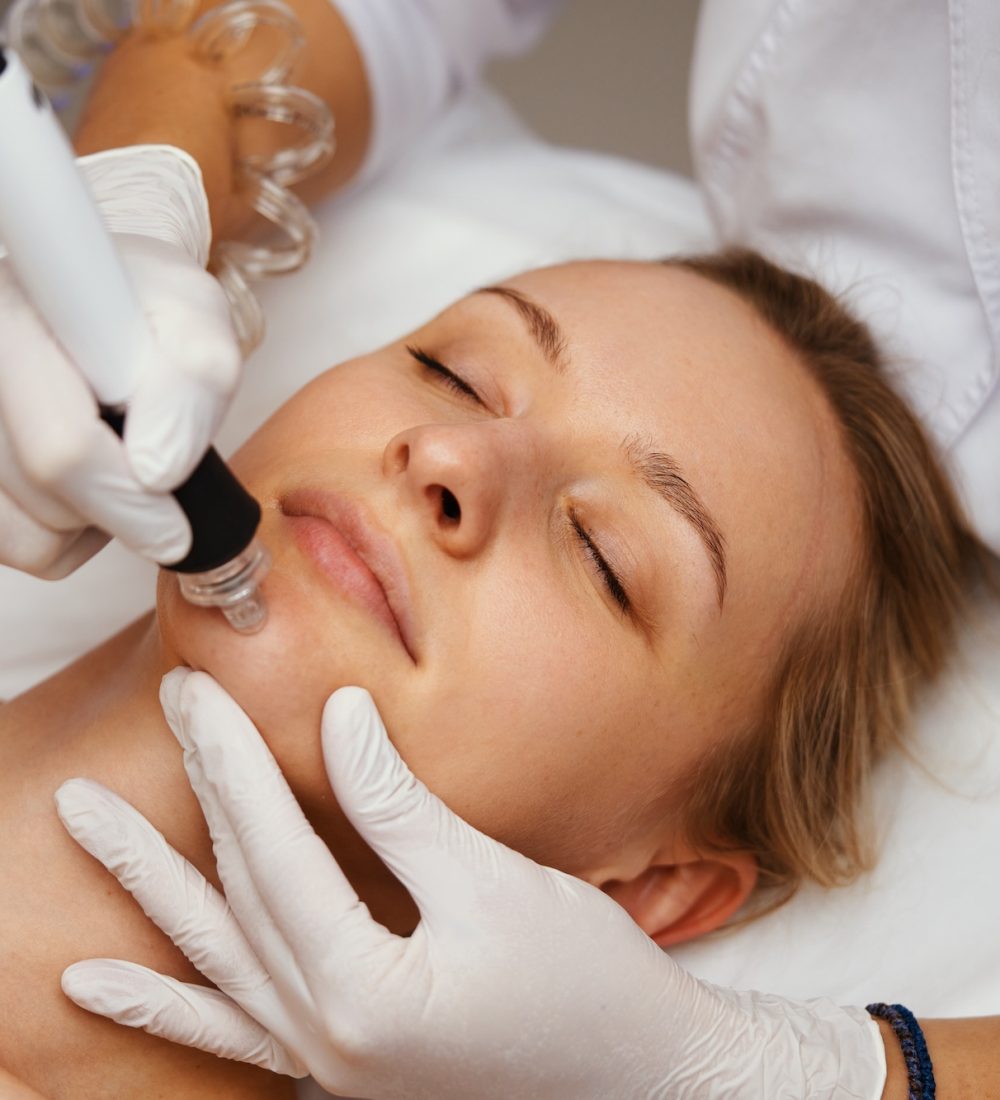 A cosmetologist performs hydropiling in a beauty salon. Skin care. High quality photo